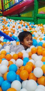 Portrait of smiling boy with multi colored balls
