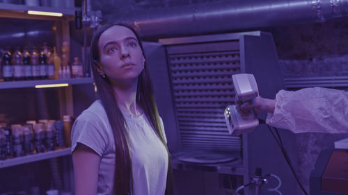 Portrait of young woman drinking coffee in gym