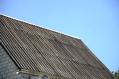 Low angle view of modern building against clear blue sky