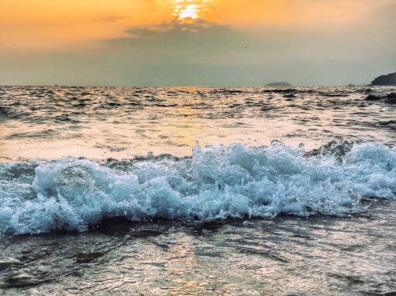 sea, water, horizon over water, wave, scenics, sunset, surf, motion, beach, beauty in nature, sky, nature, idyllic, shore, tranquil scene, power in nature, tranquility, majestic, tide, remote, ocean, waterfront, sun, non-urban scene, seascape, cloud - sky, tourism, splashing, outdoors, vacations