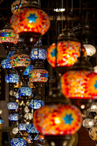 Close-up of illuminated lanterns hanging at market stall