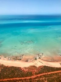 View of calm beach against blue sky