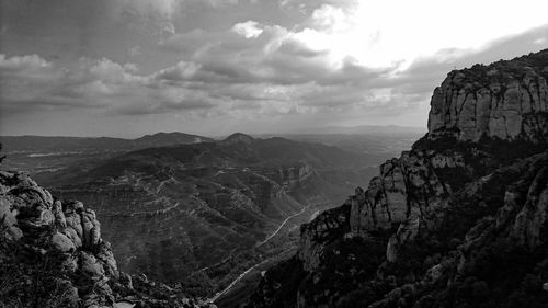 Scenic view of mountains against cloudy sky