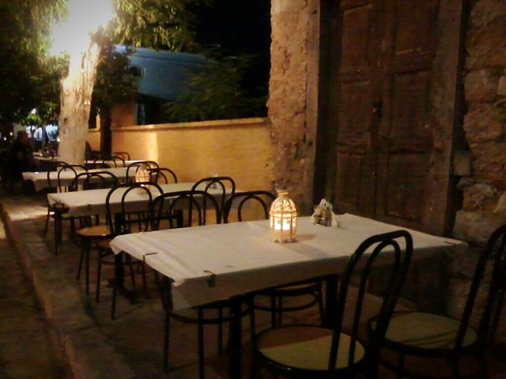 chair, absence, table, empty, seat, built structure, architecture, sunlight, furniture, day, building exterior, no people, indoors, sidewalk cafe, shadow, house, bicycle, potted plant, bench, relaxation