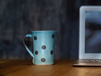 Close-up of coffee cup on table