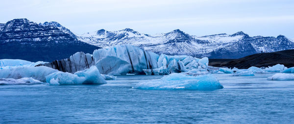 Scenic view of frozen lake against sky