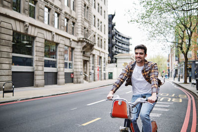 Portrait of young man on city street