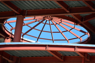 Low angle view of roof and building against blue sky