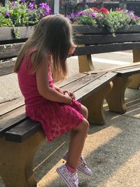 Full length of woman sitting on bench