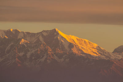 Scenic view of snowcapped mountains against sky during sunset