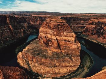 Aerial view of landscape by sea against sky