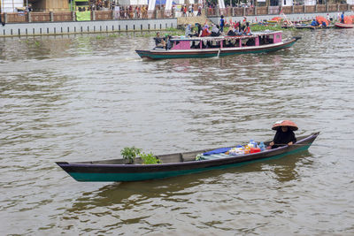 Men sitting on boat in canal