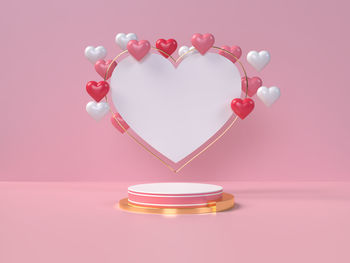 Close-up of heart shape on pink table