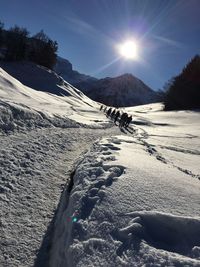 Scenic view of snowcapped mountain against sky on sunny day