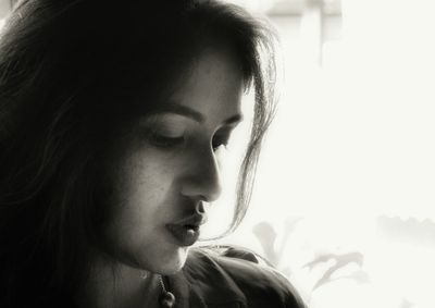 Close-up portrait of young woman looking away