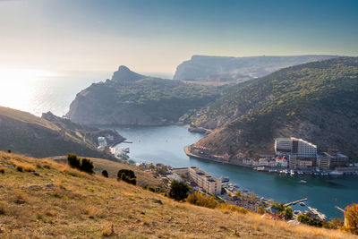 High angle view of sea and mountains against sky