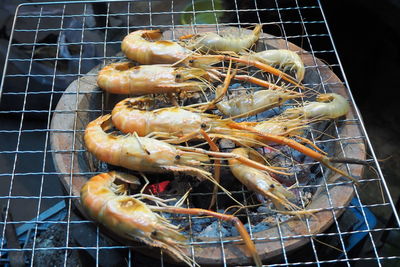 High angle view of meat on barbecue grill