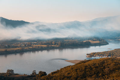 Scenic view of lake and mountains against sky