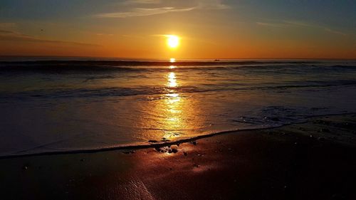 Scenic view of sea against sky at sunset