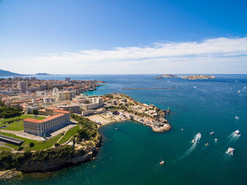 High angle view of townscape by sea against sky