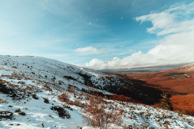 Scenic view of snow covered mountains against sky