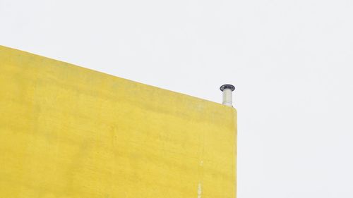 Low angle view of yellow building against clear sky