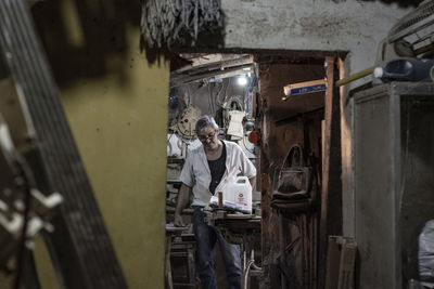 Man working on wood in building