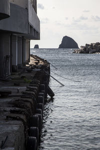 Building by sea against sky