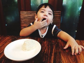 Close-up portrait of happy boy eating food