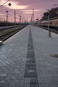 Railroad tracks against sky during sunset