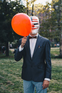 Portrait of man holding balloons