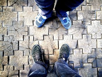 Low section of man standing on footpath