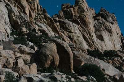 Low angle view of rocks against sky