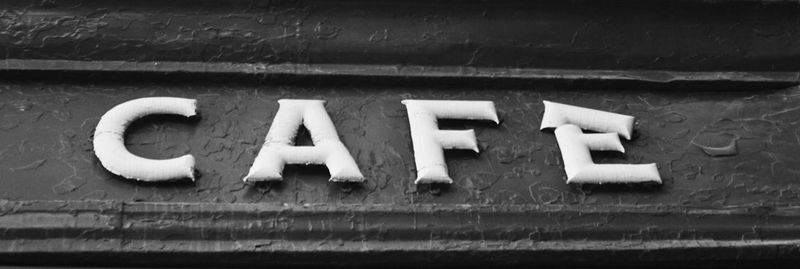 Close-up of information sign on wall