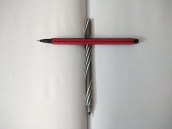 Directly above shot of pencil on table against white background