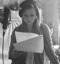 Close-up of young woman holding paper