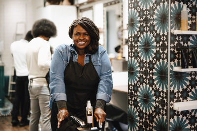 Portrait of smiling female barber at hair salon