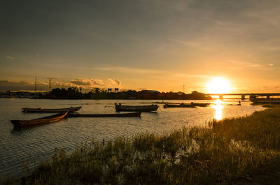 Scenic view of river against sky during sunset