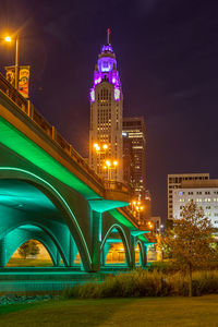 Illuminated buildings against sky at night