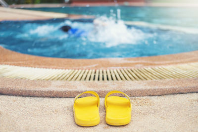 Close-up of sunglasses on swimming pool