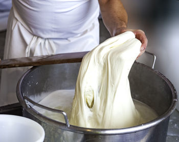 Midsection of man preparing food in kitchen