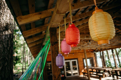 Low angle view of lanterns hanging on roof of building