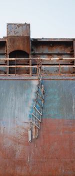 Old rusty metallic structure against sky