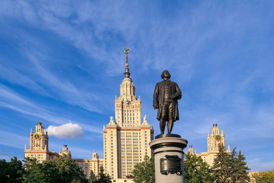 Sunny main building of moscow university with monument of its founder lominosov under blue sky