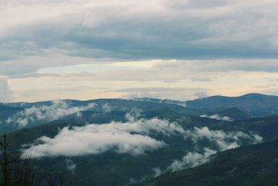Scenic view of mountains against cloudy sky