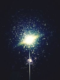 Low angle view of firework display at night