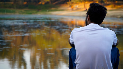 Rear view of woman looking at lake