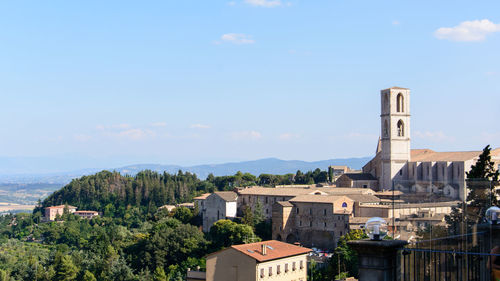 Buildings in town against sky