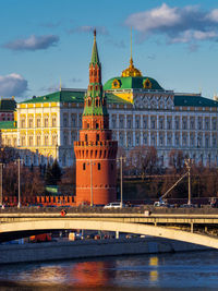 Bridge over river against buildings in city