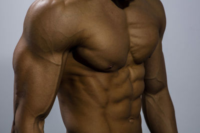 Midsection of shirtless muscular man